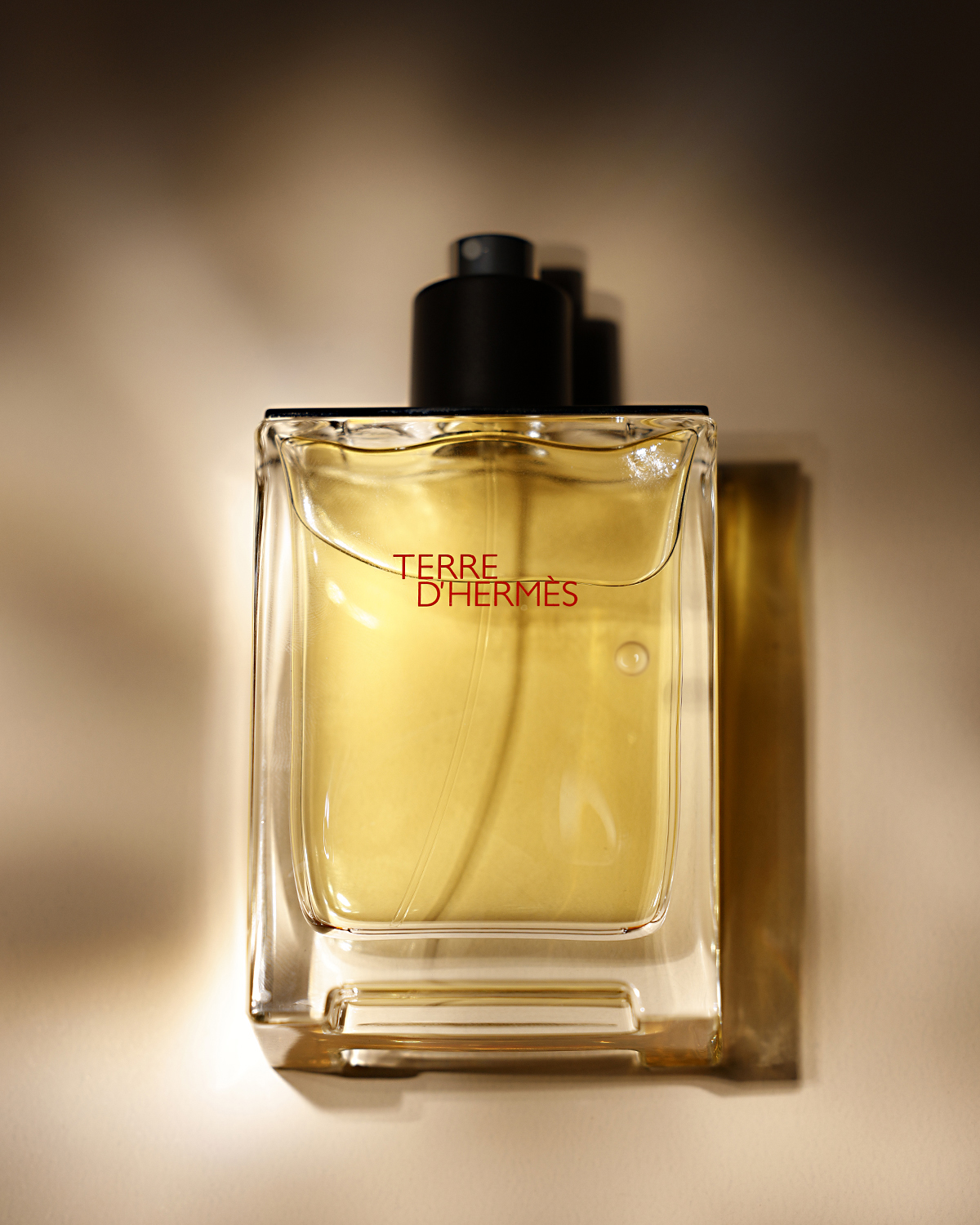 Luxury perfume bottle on beige fabricadhsofjadkfnklsdnfsddfosdfnsdndfdksiofdofododofof