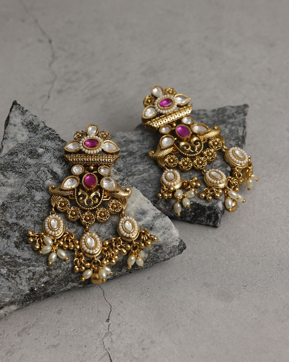 Traditional gold earrings with red and white embellishments