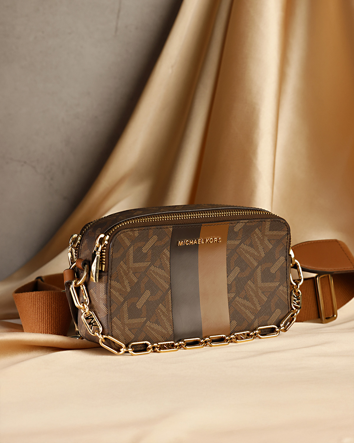 Brown leather handbag with strap on beige surface